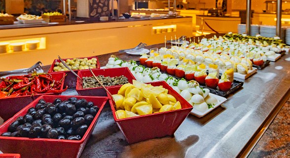 Buffet mit Oliven, Zitronen, gefüllten Eiern, Käsehäppchen und Antipasti in einem Hotelrestaurant.