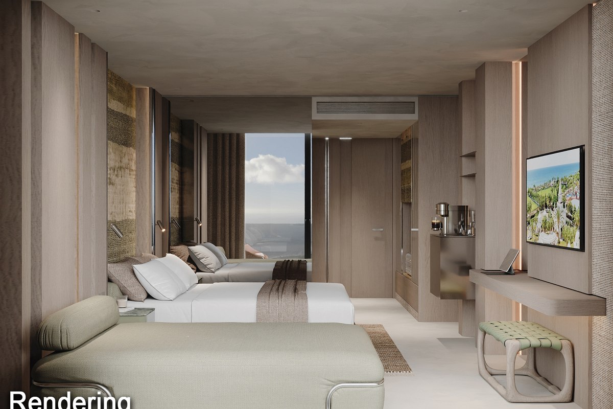 Modernes Hotelzimmer mit Doppelbett, Sitzbereich, Flachbild-TV, Schreibtisch, Blumen und Obstschale auf dem Tisch.