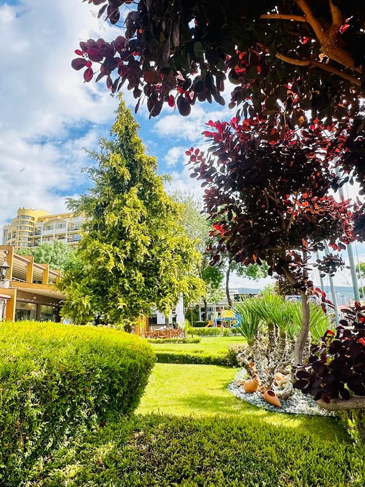 Extensive beach with bright blue water, fine sand and plenty of parasols with sun loungers.