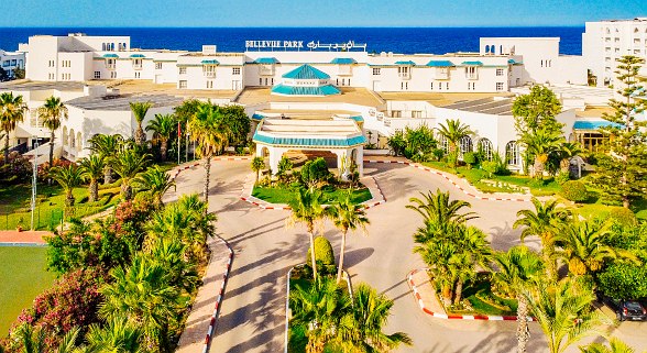 Aerial view of the Sentido Bellevue Park Hotel with palm-lined driveway and view of the blue Mediterranean.