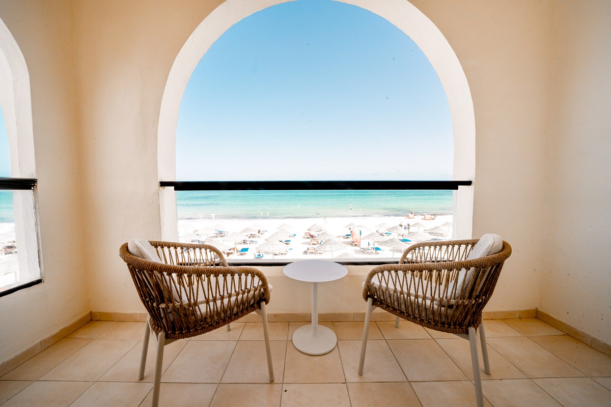 Cozy balcony with a view of the beach and the sea, perfect for relaxing.
