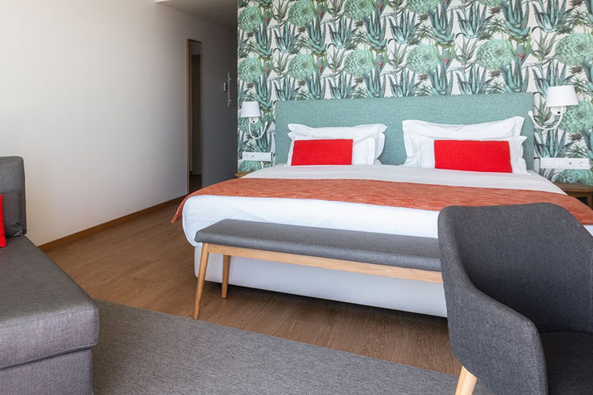 Modern room with tropical flair, bold color accents and stylish, cozy ambience.