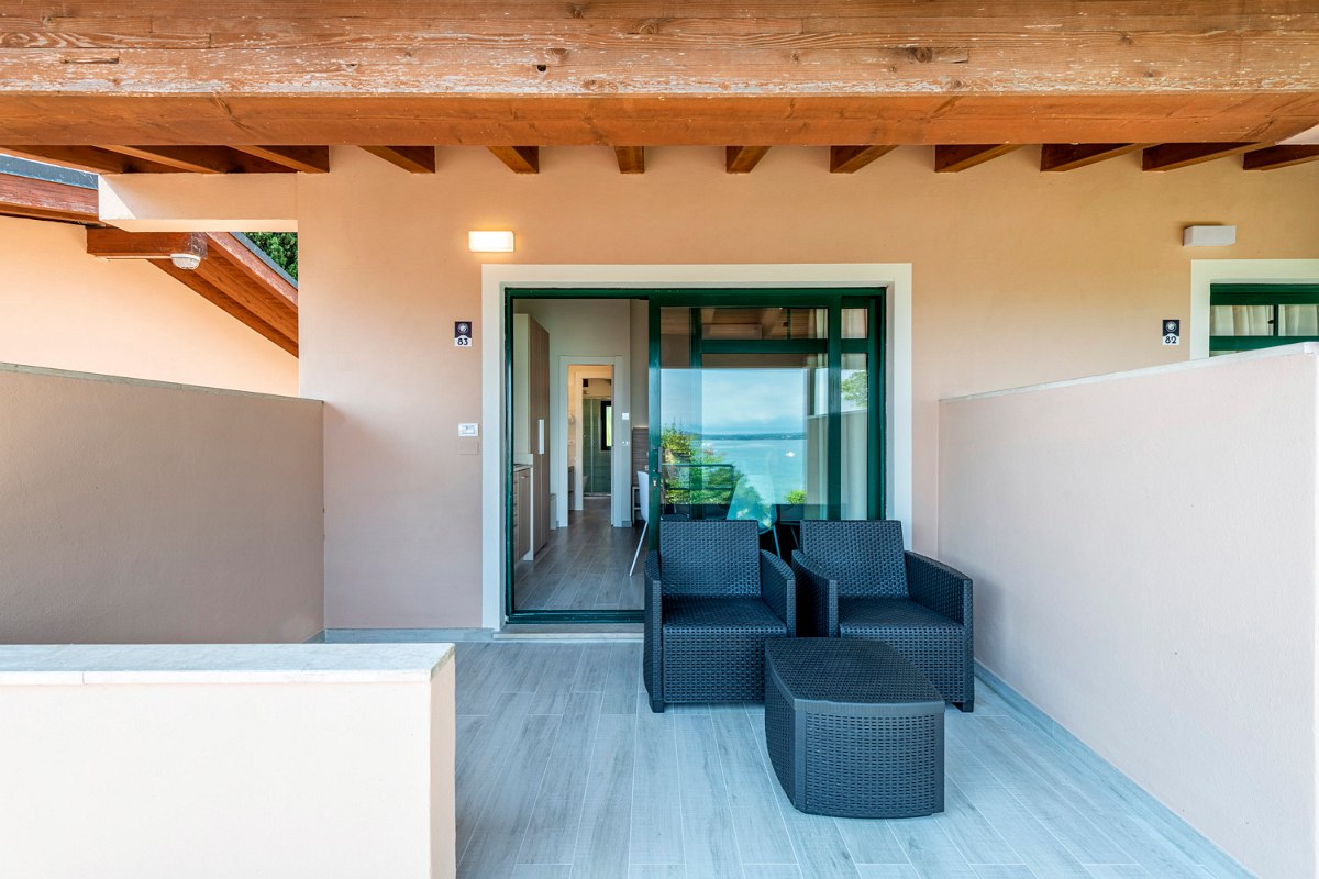 Roofed Balcony with direct lake-view and comfortable seating furniture.