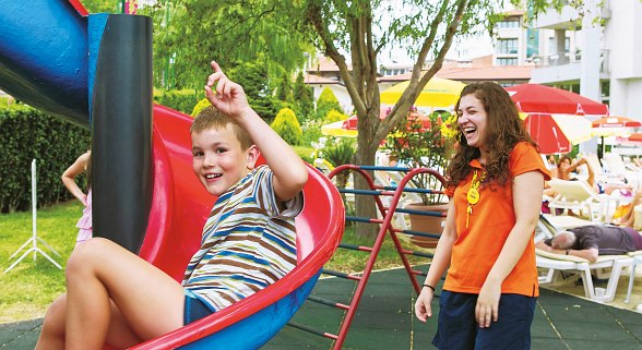  Hotel Sentido Neptun Beach children's playground and animation: colorful playground with slides, climbing frame and swings, green lawn, sunshades, animation team, children playing and having fun.