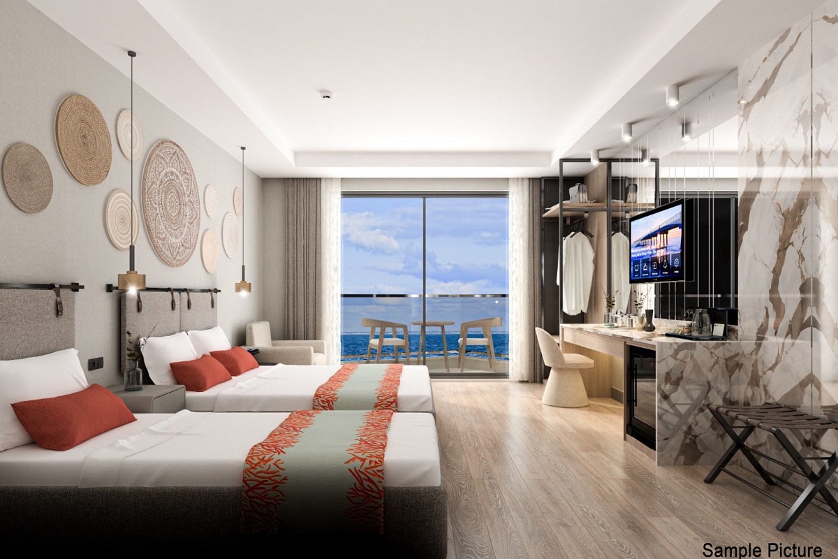 Elegant hotel room with two beds, stylish interior and balcony with fantastic sea view at dusk.