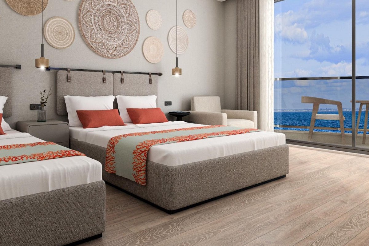 Modern family room with separate sleeping areas, stylish design, carpeted floor and access to the balcony with natural light.