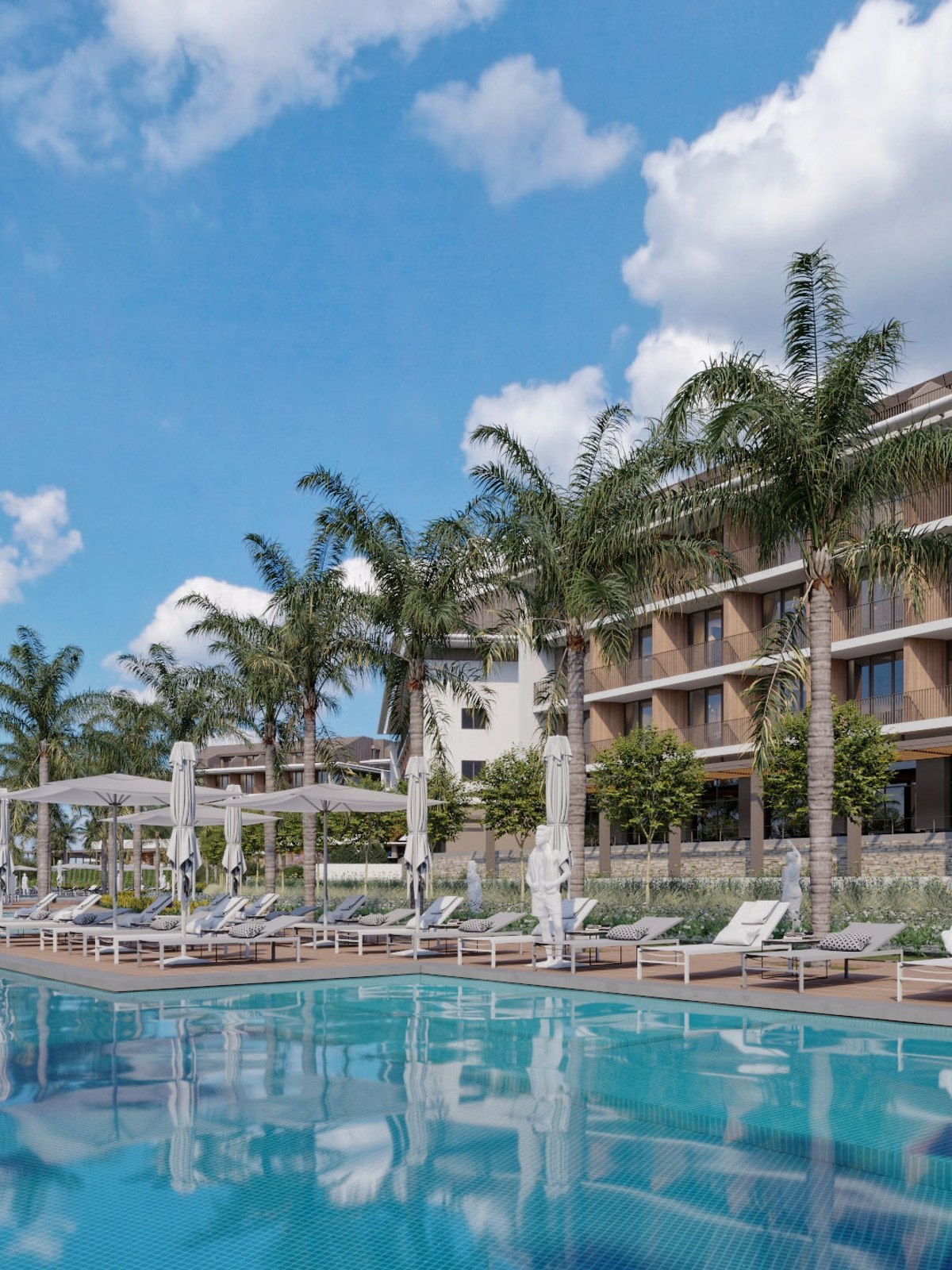 Magnificent hotel with a white façade and towers, surrounded by palm trees and yellow flowers.